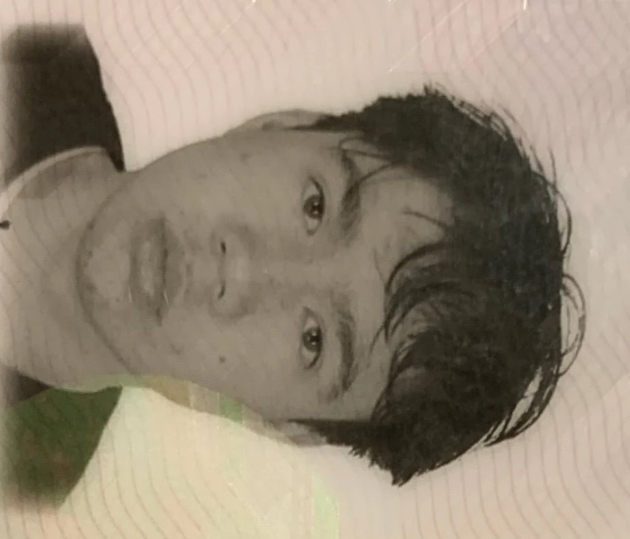 Monochrome identity photograph of Villanueva, rotated 90 degrees