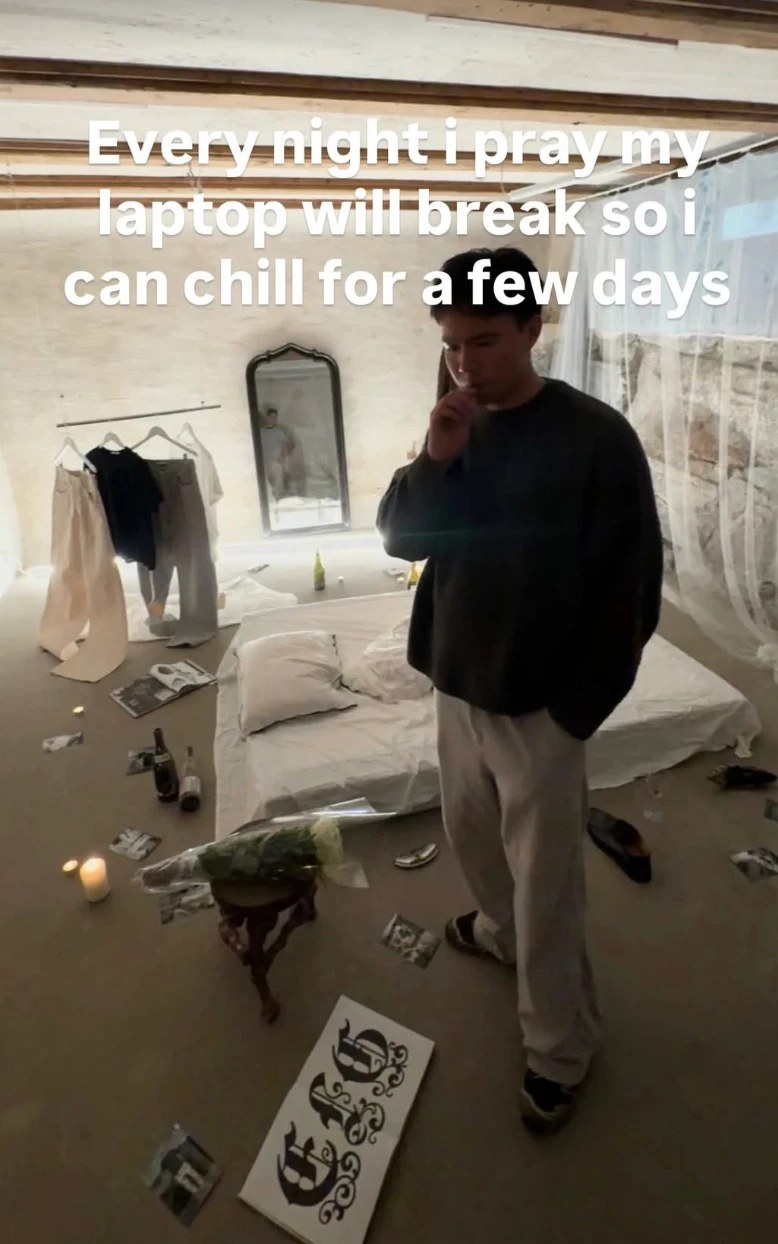 Villanueva standing in a bedroom among candles, bottles and photographs, in a social media post captioned 'Every night i pray my laptop will break so i can chill for a few days'